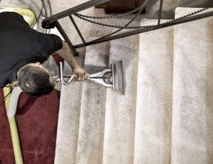 Professional carpet cleaner cleaning the steps in a home
