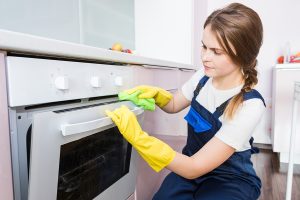 Cleaning service with professional equipment during work. professional kitchenette cleaning, sofa dry cleaning, window and floor washing. man and women in uniform, overalls and rubber gloves